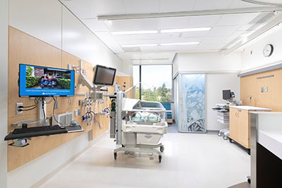 A hospital room with a NICU bed