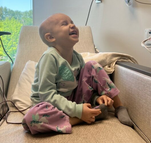 A Seattle Children’s patient smiles while hearing her favorite song