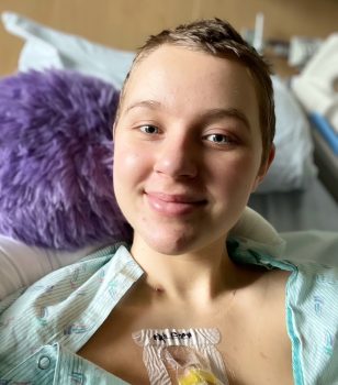 teen smiles from her hospital bed