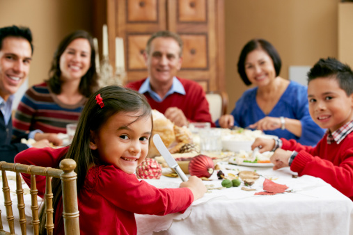 A family enjoys a holiday dinner together at the table