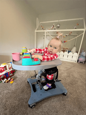 Toddler girl in an adaptive chair