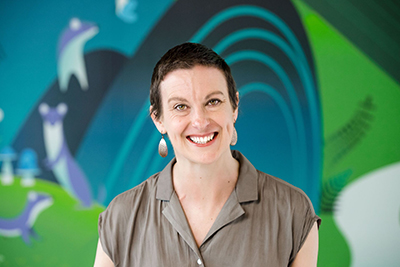 A closeup photo of a woman smiling so kindly at the camera