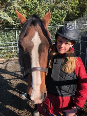 Jasmine poses with a horse.