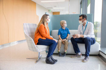 A boy and his mother chat with a Seattle Children's doctor