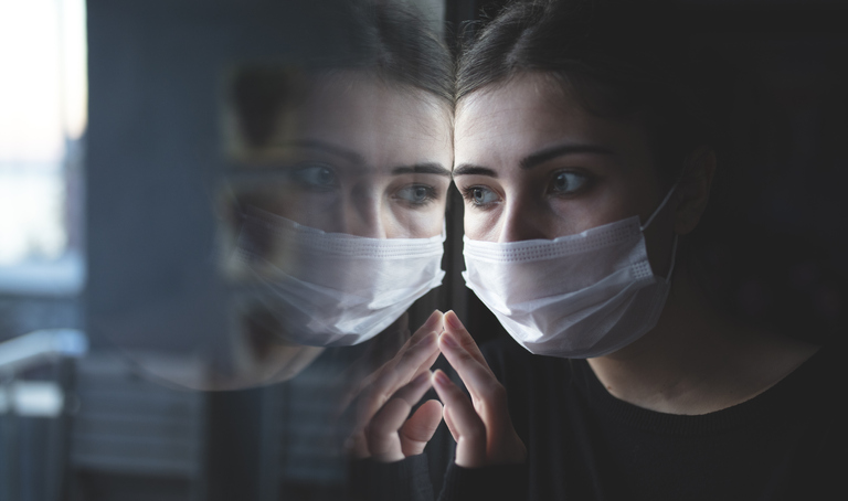 A patient contemplates their future while staring out of a window. 