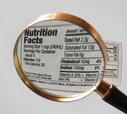 Magnifying glass looking over a food label.