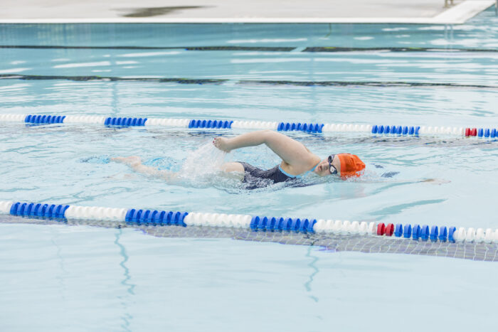 A young woman swims in a pool