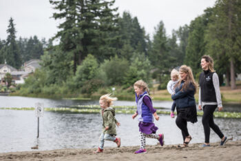 A family walks along a beach