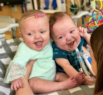 Two preemie twins, a boy and a girl, at 10 months old