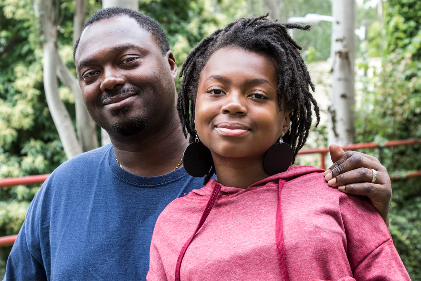 Daughter and Dad smiling at the camera