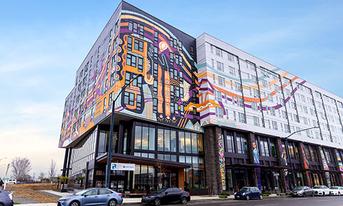 The outside of OBCC’s new clinic in Othello. The building is painted with a colorful mural of purple and orange.