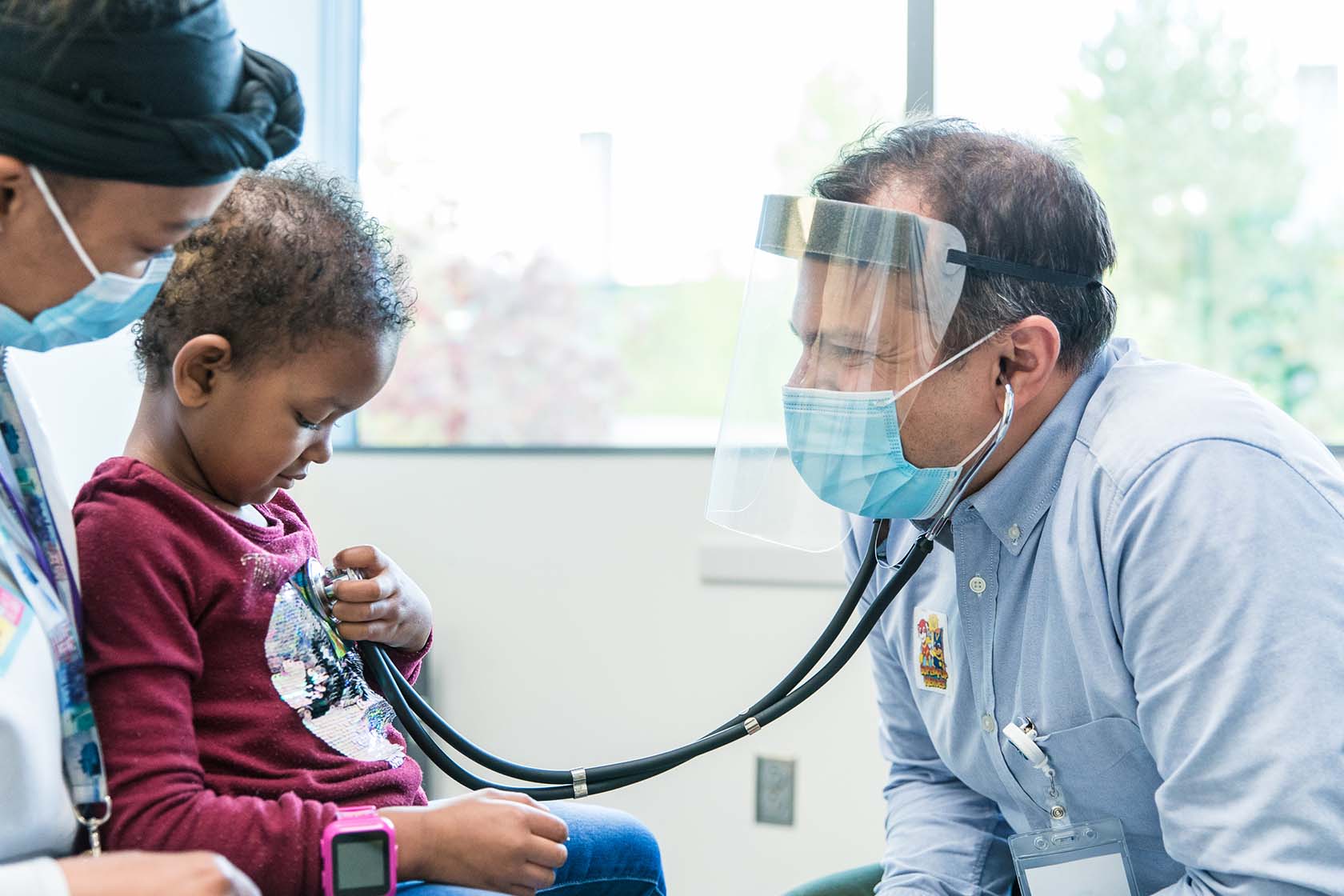 Dr. Pinto with a patient at Seattle Children's