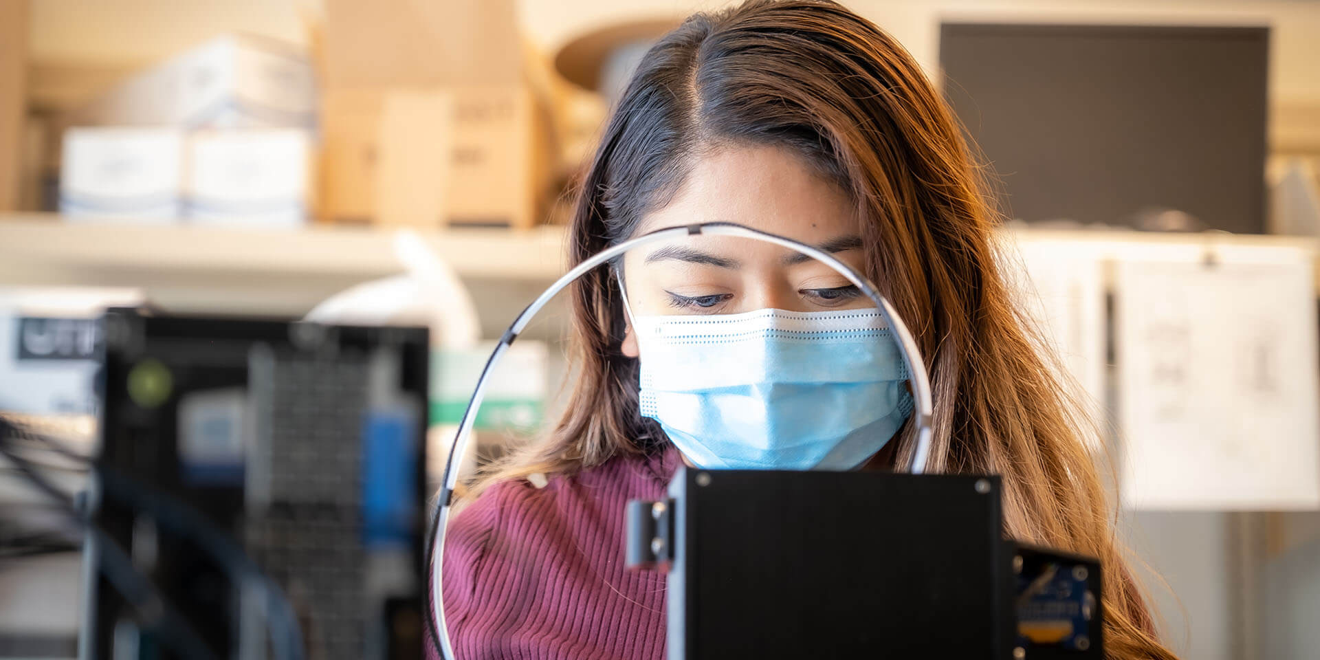 A medical lab researcher inspects a project.