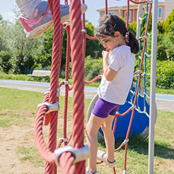 A girl climbs a robe wall