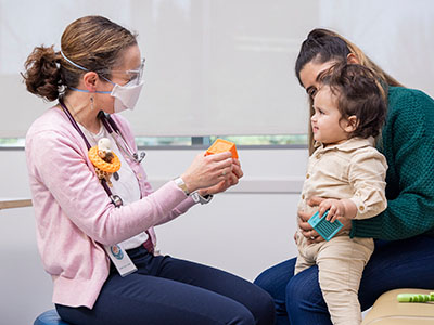 A Seattle Children's doctor with a young patient