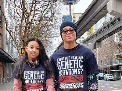 Two Seattle Children's patient standing outside with the Space Needle in the background