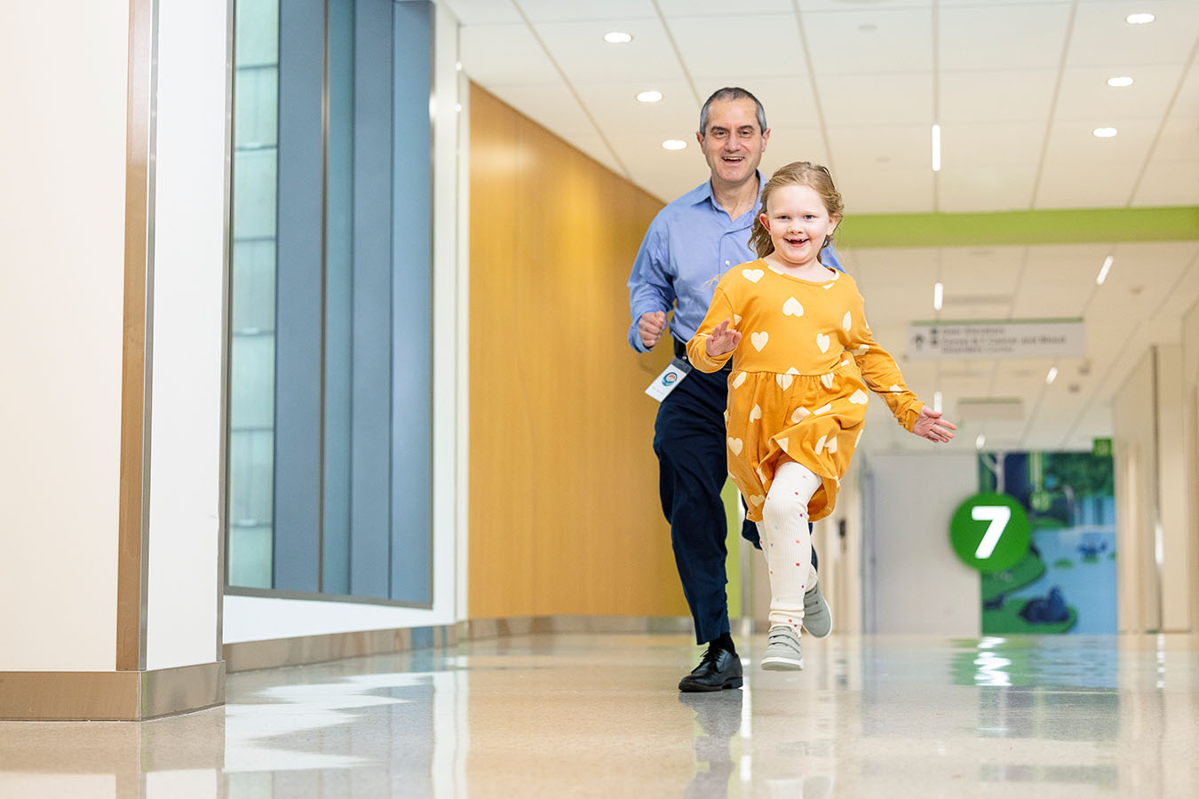 Dr. Ralph Ermoian races Aisley down the hall