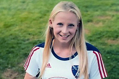 A teen girl in a soccer uniform