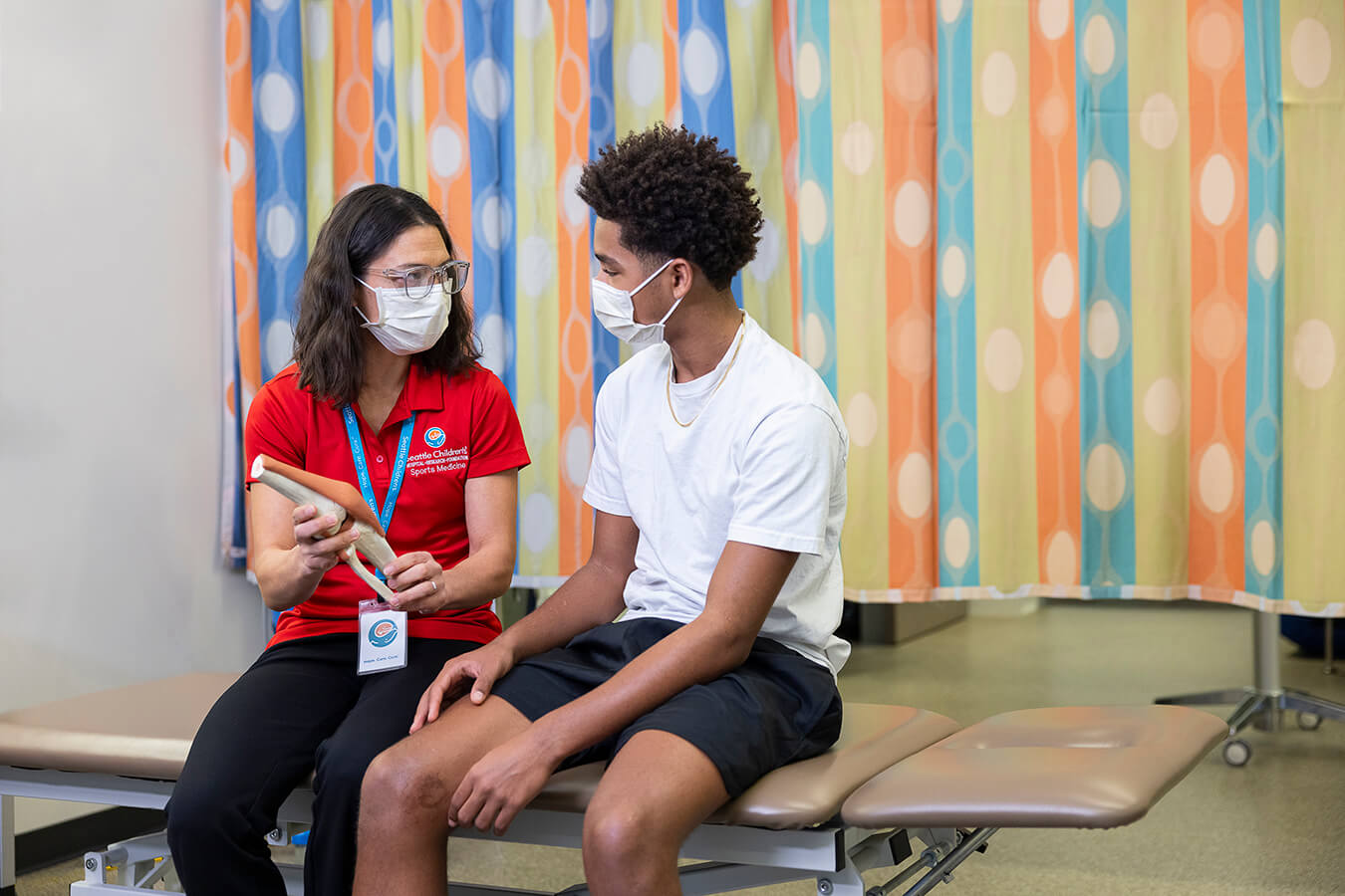 A physician talking to a boy