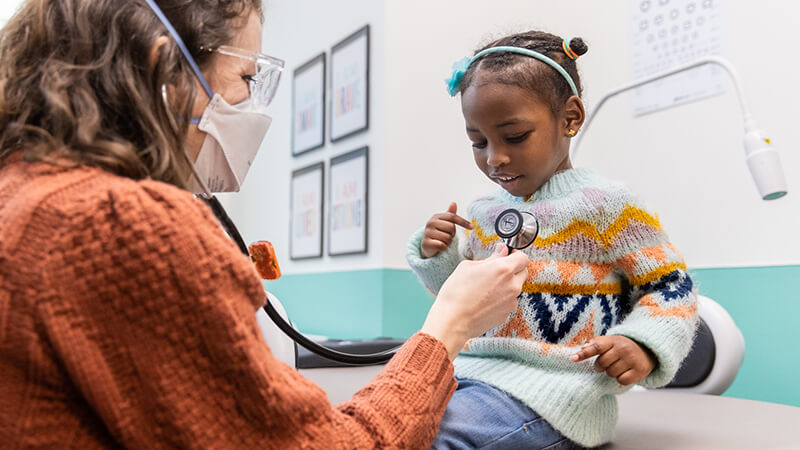 Doctor with stethoscope and patient being treated for sickle cell disease