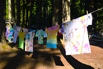 Tie-dyed T shirts drying on a clothesline