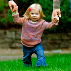 A toddler girl walking