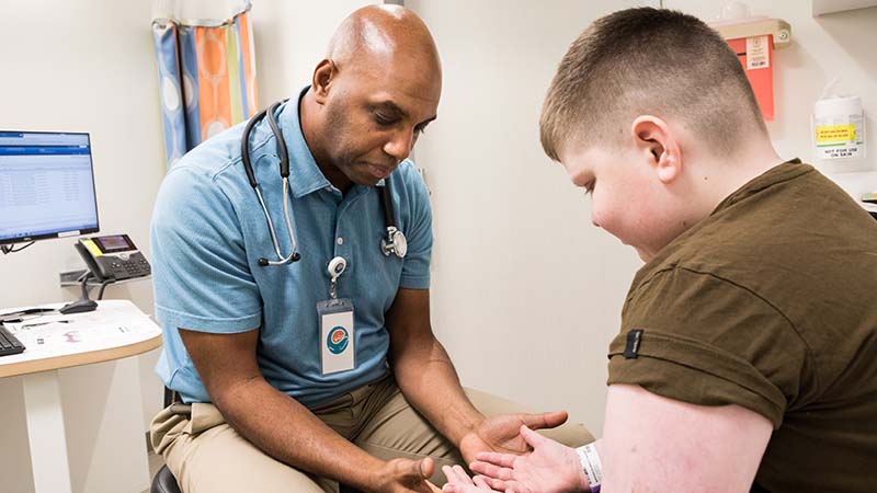 A boy meets with a Seattle Children's doctor