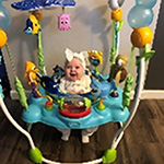 A baby in a bouncer