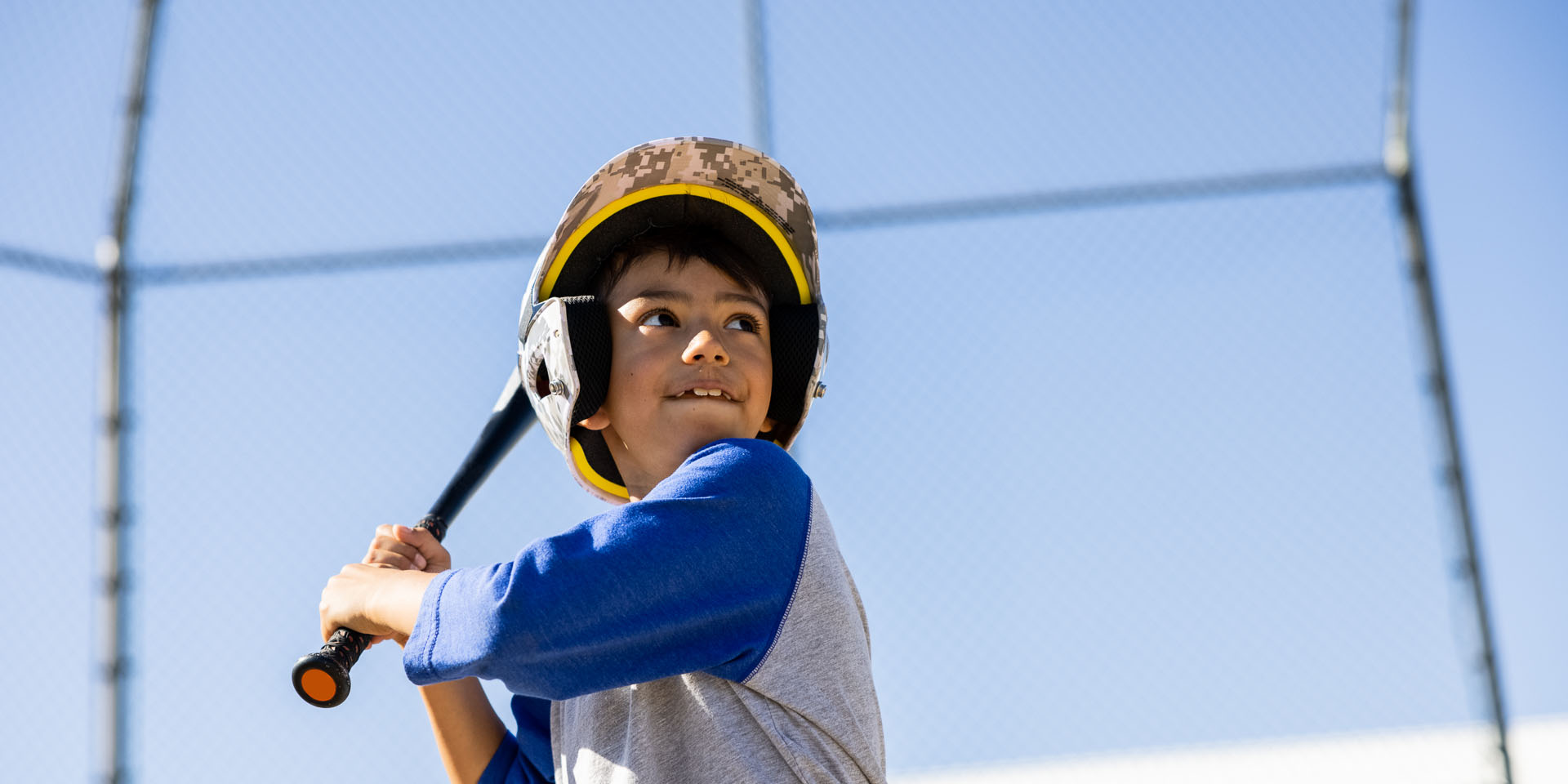 A boy swings a baseball bat during a game