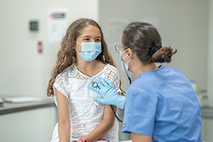 A teen girl getting an exam by her pediatrician