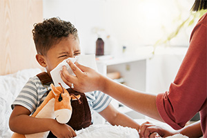 a sick toddler with their parent