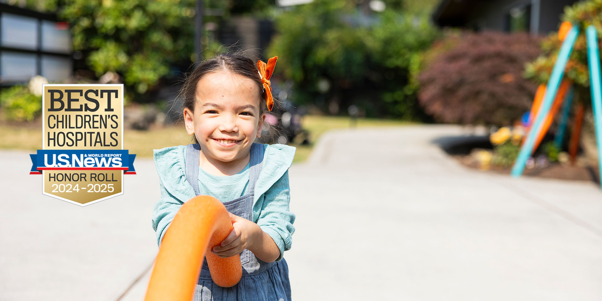 A girl holds a pool noodle