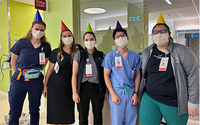 Residents in birthday hats pose for the camera