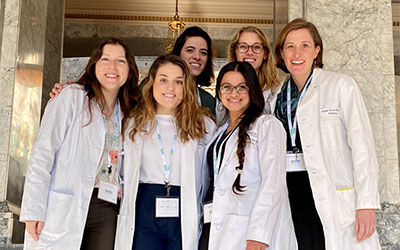 A group of people in lab coats pose for a picture