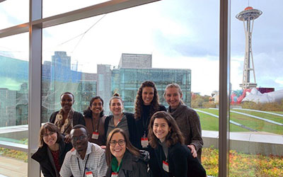 Seattle-based residents pose with the Space Needle in the background.