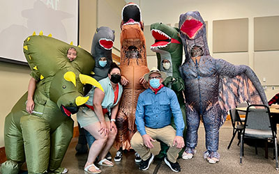 Residents pose in Jurassic Park costumes