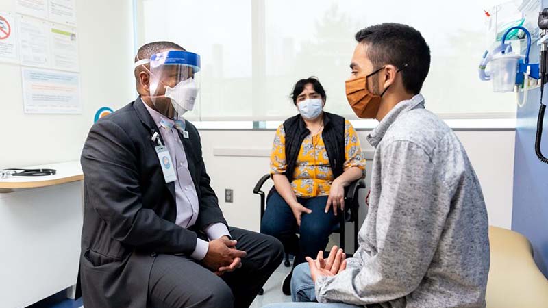 A doctor speaks to a patient