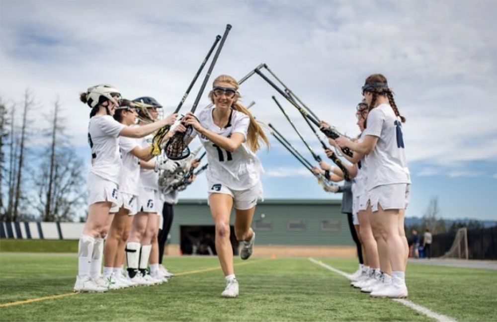 Teen girls play lacrosse