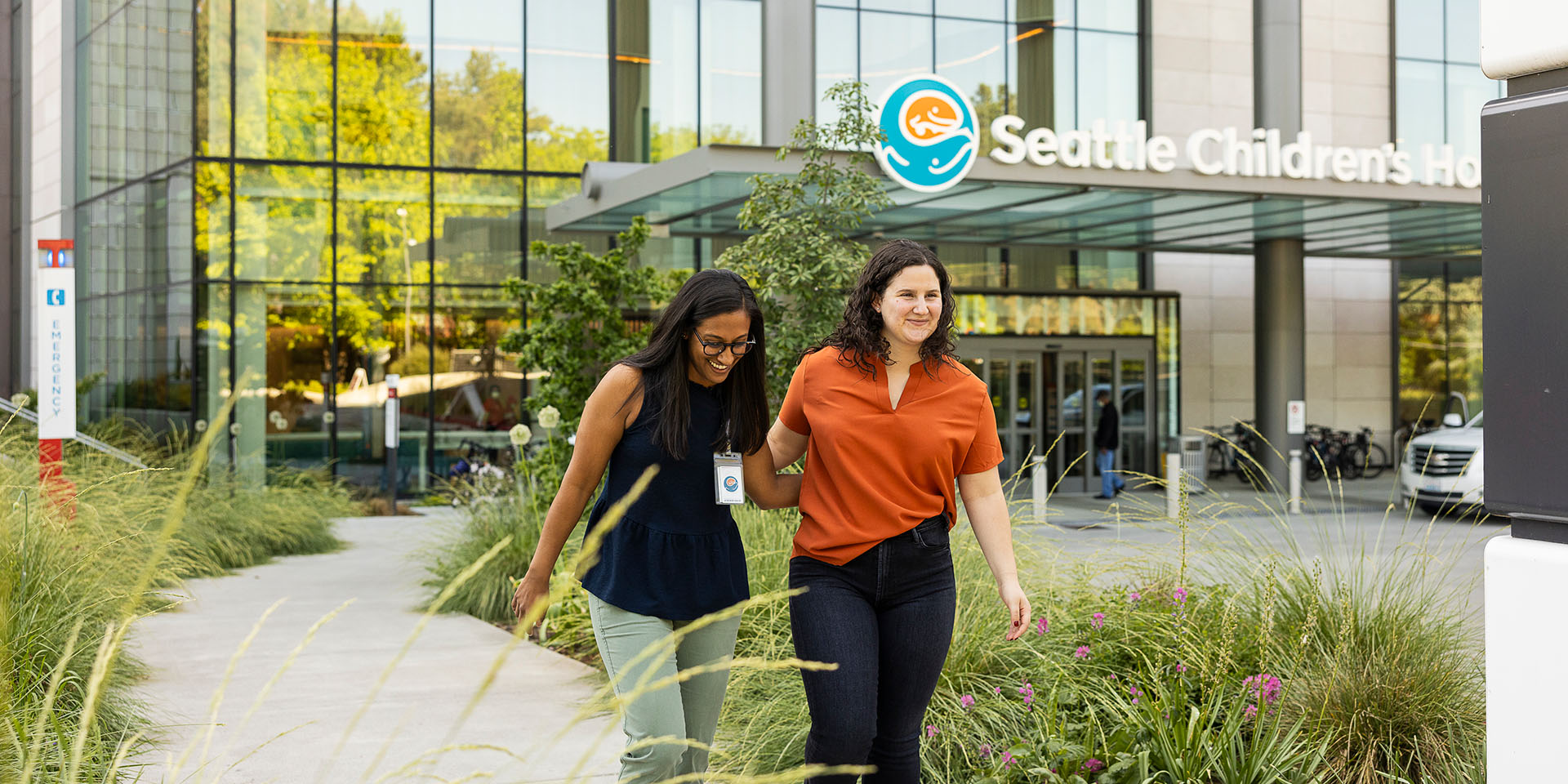 Two woman walk outside of Seattle Children's Hospital