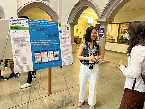 Woman giving a poster presentation