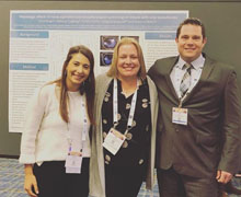 Team in front of their poster